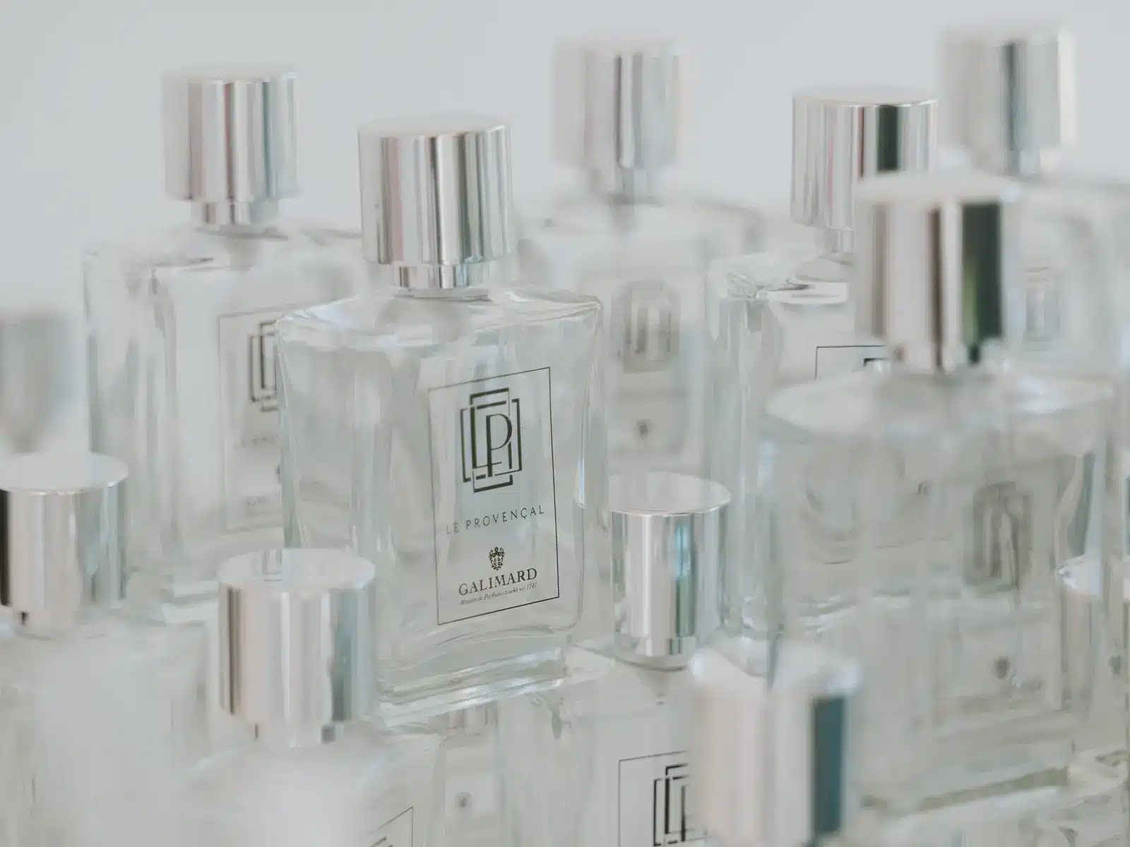 Clear glass perfume bottles with silver caps display "Le Provençal" branding by Galimard. Minimalist design, reflecting a classic and elegant fragrance presentation.